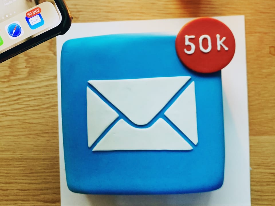 A cake shaped like Apple Mail icon with 50K notification badge